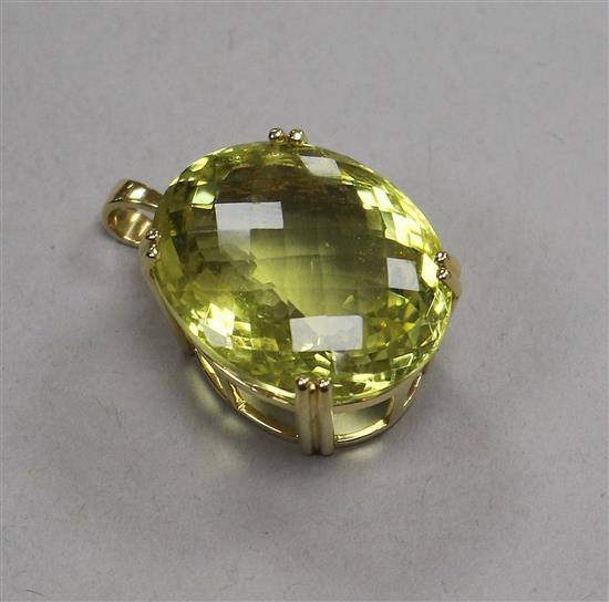 A modern 18ct gold and fancy cut pale green quartz oval pendant, 24mm.
